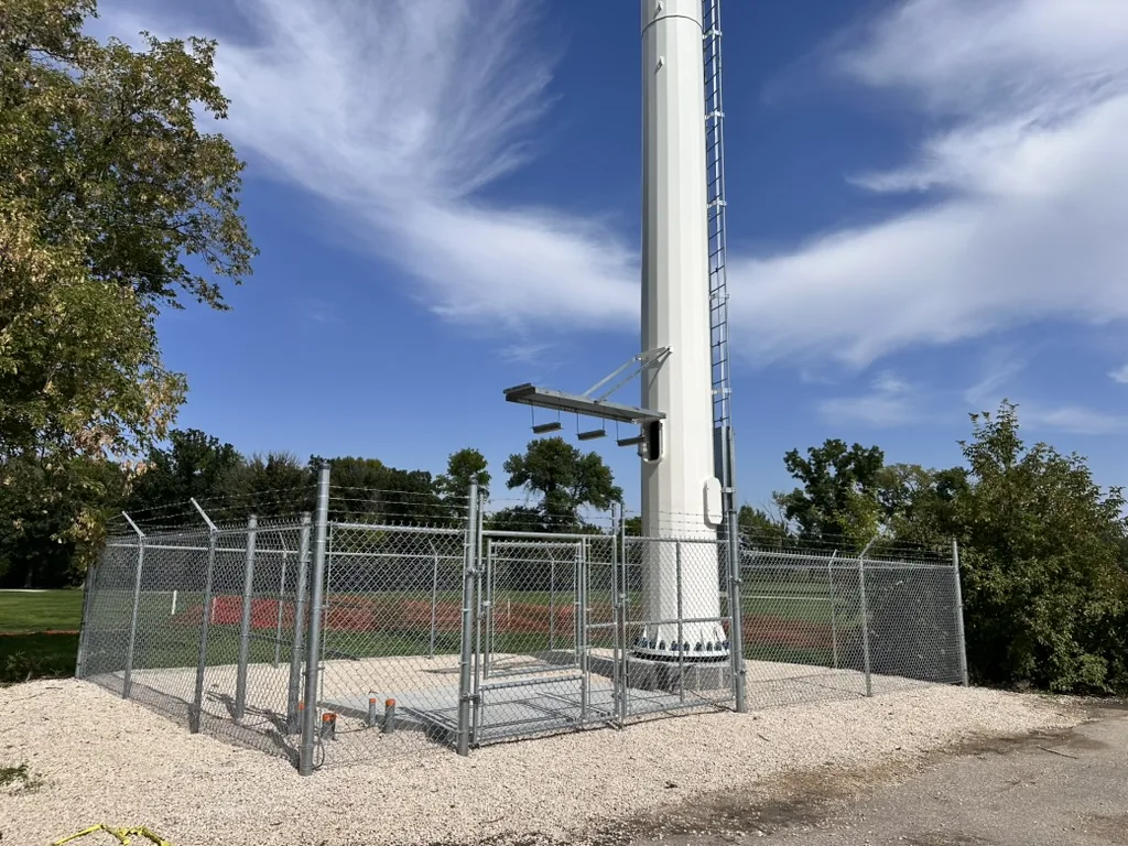 Chain link perimeter with barbed wire topping