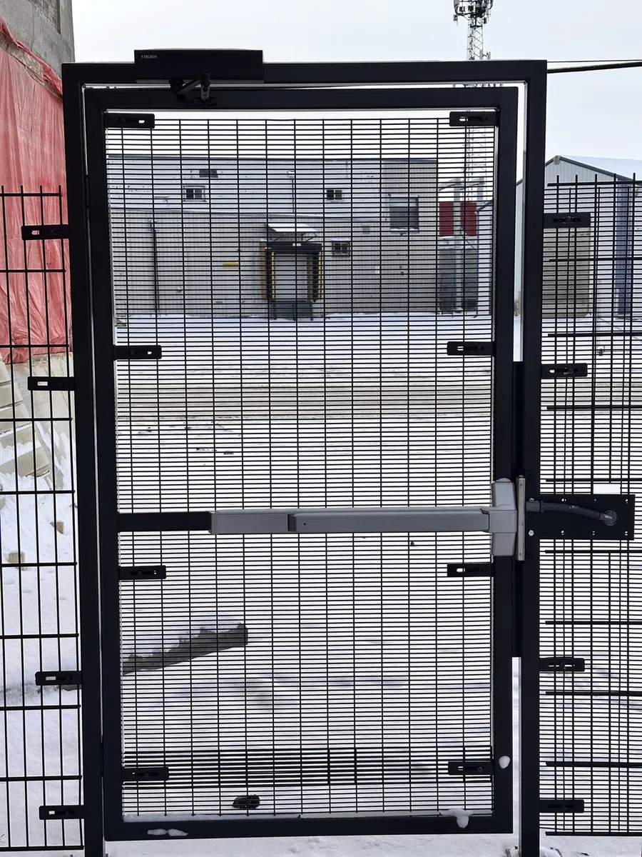 Pedestrian security gate with a door closer, panic bar and electric strike