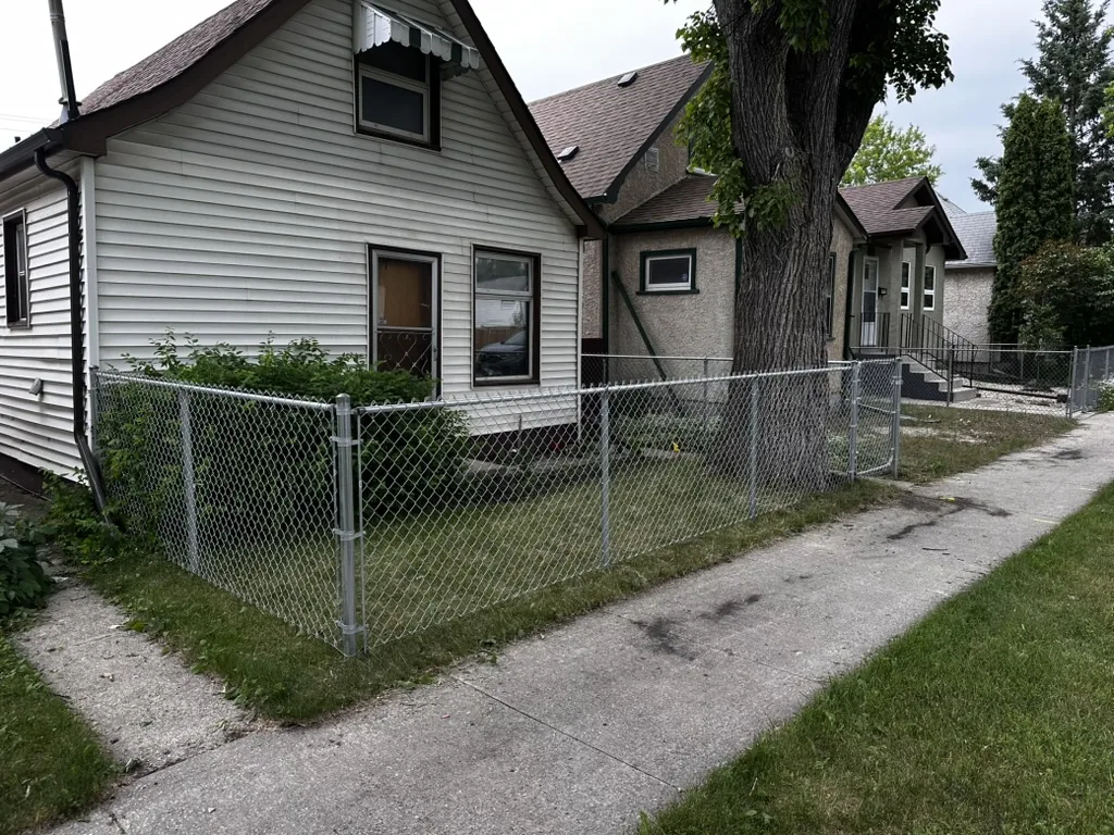 Galvanized chain link fence in front yard