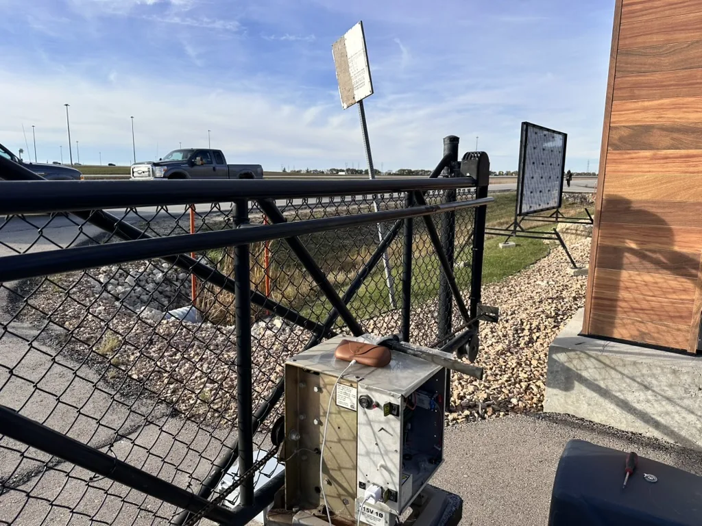 Solar-powered automatic gate operator on an acreage entrance