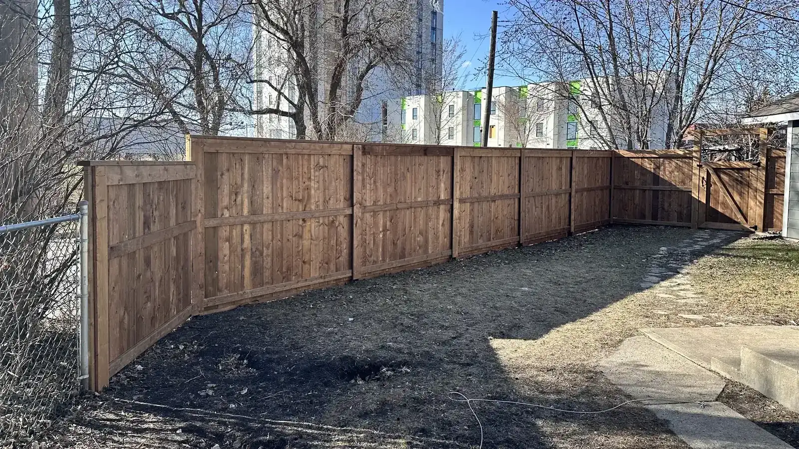 Long wood privacy fence along a back yard