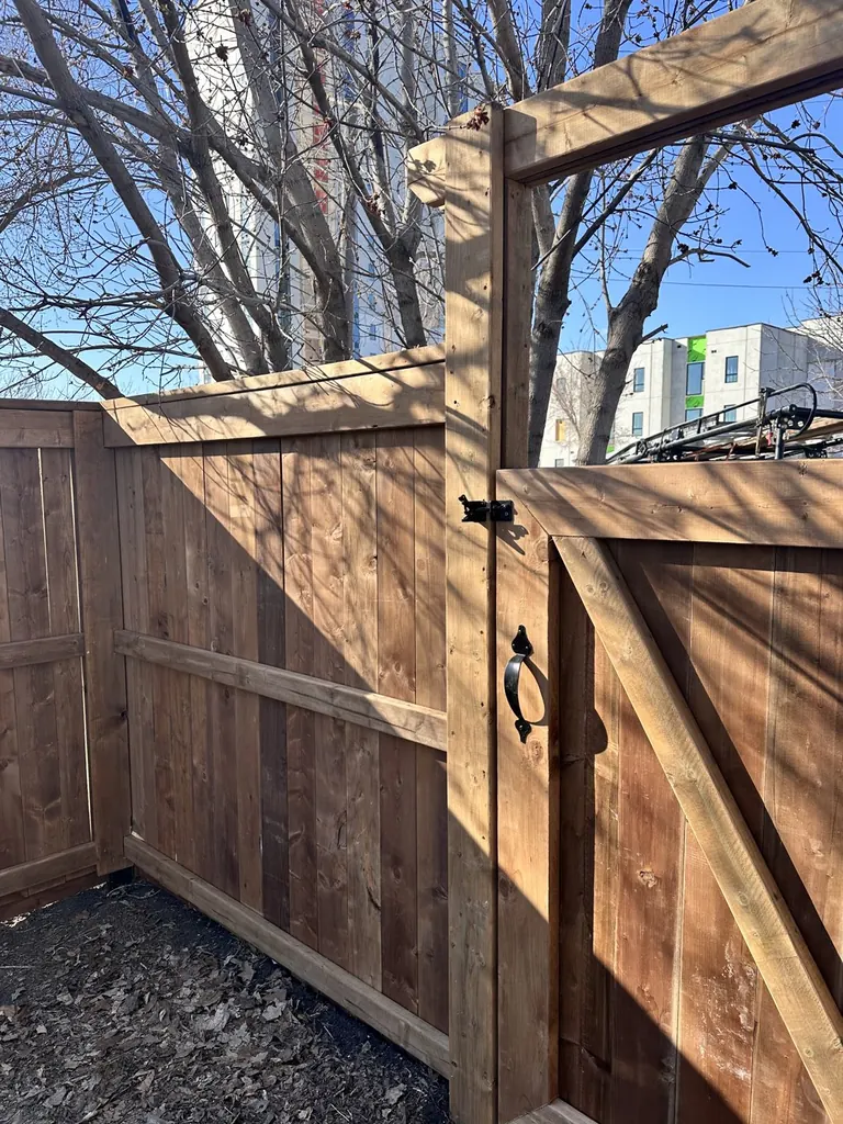 Vertical cedar picket fence with a walk gate